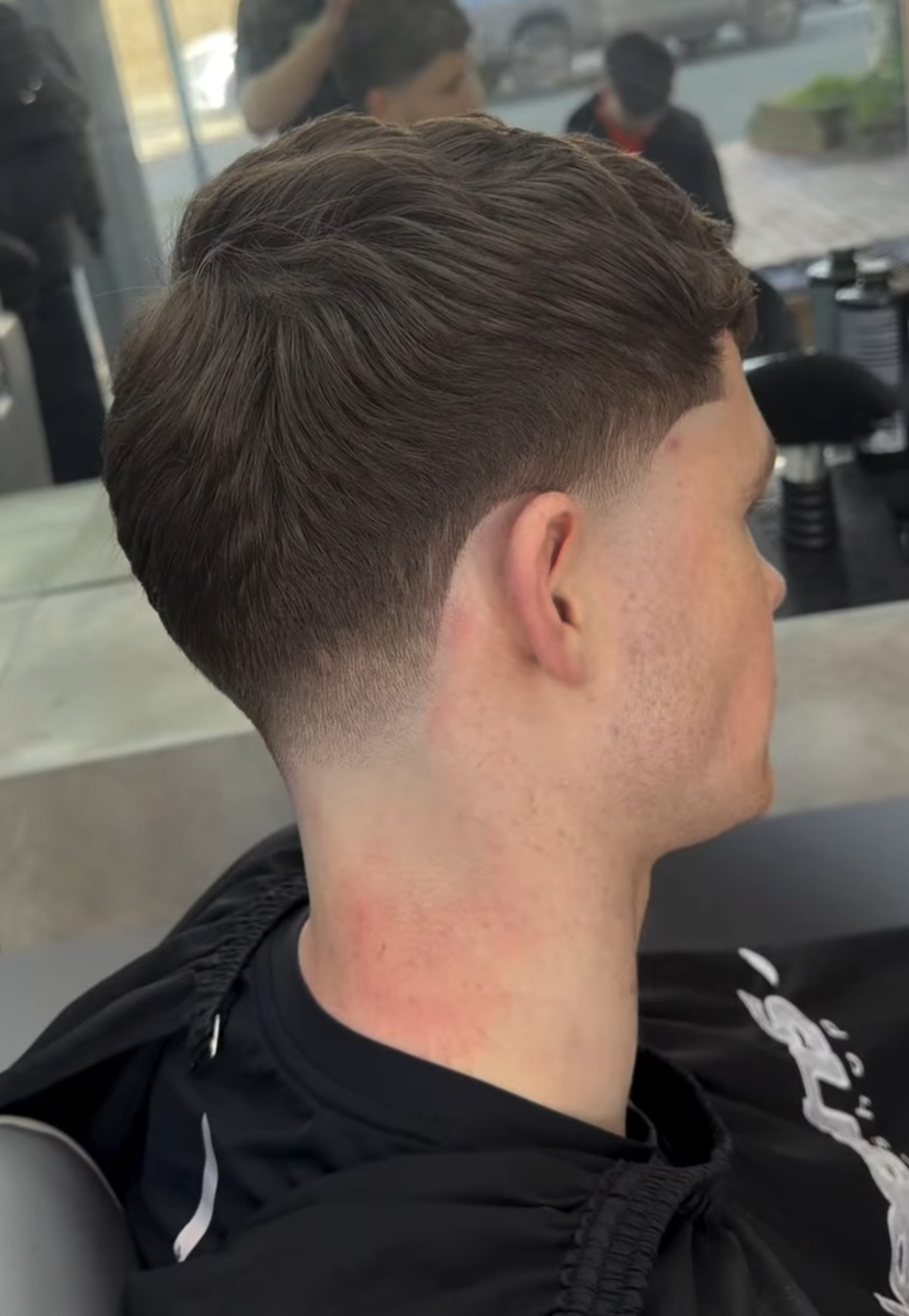 Textured flow on top with a clean taper fade