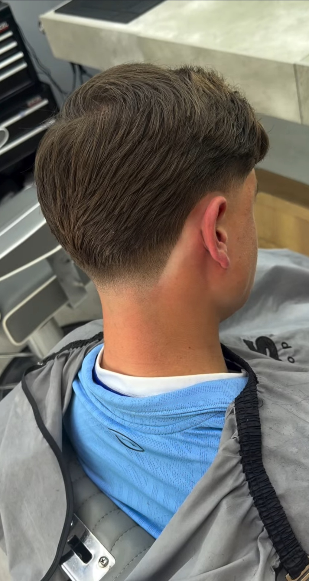 Taper fade with longer textured fringe